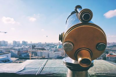 Close-up of binocular cityscape at observation point