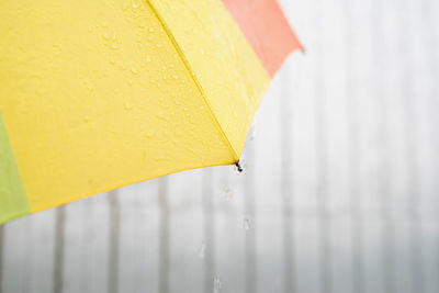 Rain drops on a colorful umbrella. close up of colorful umbrella part with raindrops
