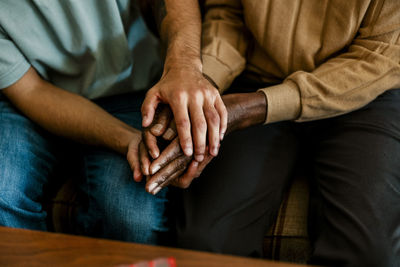 High angle view of male caregiver giving emotional support to senior man