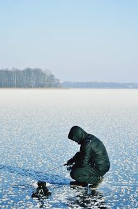 Scenic view of lake against clear sky during winter