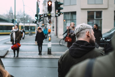 Rear view of people walking in city