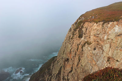Scenic view of sea and mountains against sky