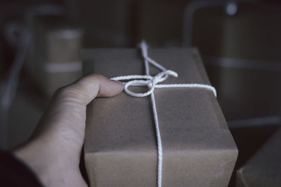 Close-up of human hand holding box