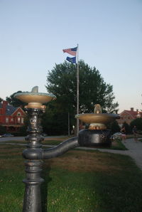 American flag in front of church against clear sky