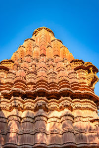 Ancient hindu temple architecture with bright blue sky from unique angle at day