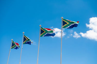 Low angle view of flag against clear blue sky