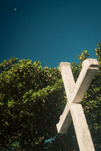 Low angle view of cross against clear blue sky