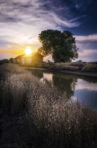 Scenic view of lake against sky during sunset