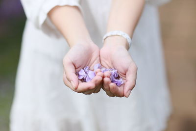 Close-up of woman holding flower