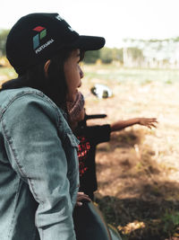 Side view of woman wearing hat