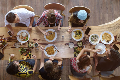 High angle view of people eating food at dining table