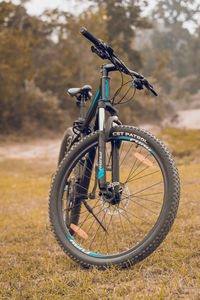 Close-up of bicycle parked on field