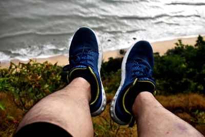 Low section of man relaxing on land