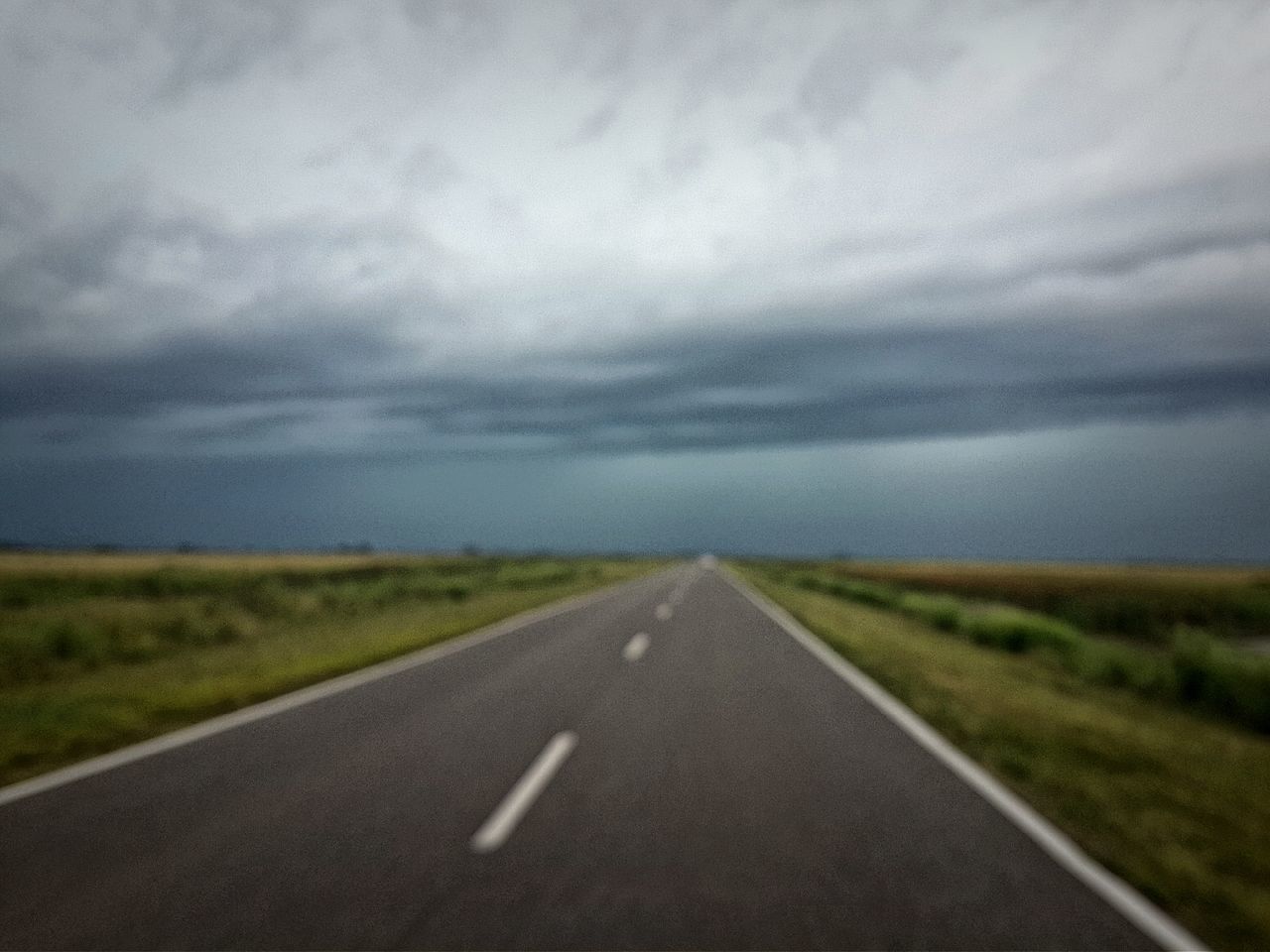 the way forward, road, transportation, diminishing perspective, road marking, sky, vanishing point, country road, cloud - sky, asphalt, landscape, empty road, cloudy, tranquility, empty, tranquil scene, field, nature, cloud, grass