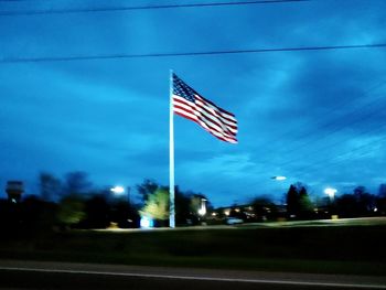 Flag against blue sky in city