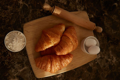 High angle view of croissants and ingredients on a table.