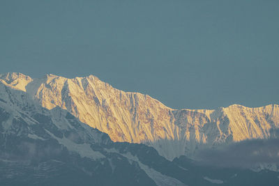 Scenic view of snowcapped mountains against clear sky