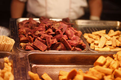 High angle view of food in containers with person in background