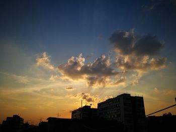 Low angle view of building against sky at sunset