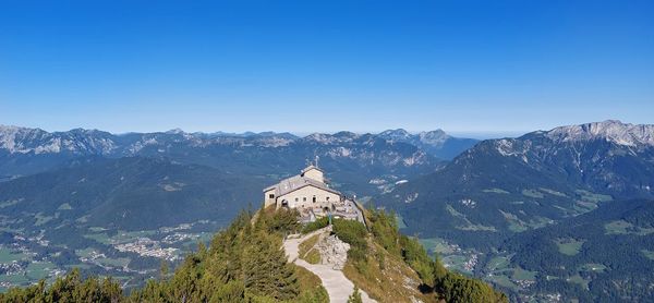 Scenic view of mountains against clear blue sky