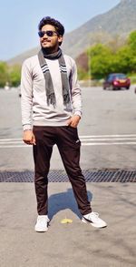 Portrait of young man standing on road