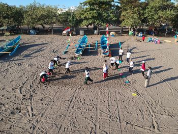 High angle view of people on sand at beach