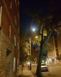 Illuminated city street at night