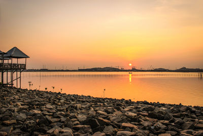 Scenic view of sea against orange sky