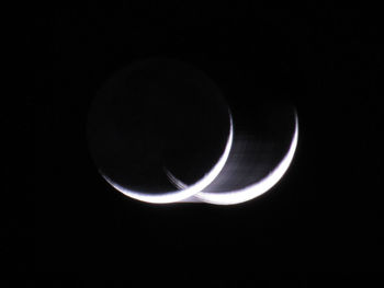 Close-up of light bulb over black background