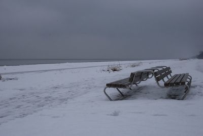 Scenic view of snow covered field against sky