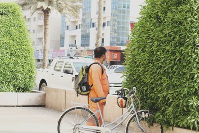 Side view of man riding bicycle in city