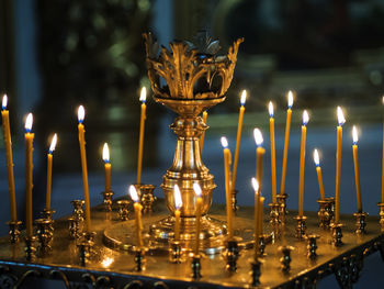 Close-up of lit candles on altar