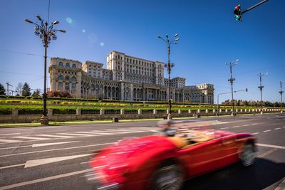 View of city street against blue sky