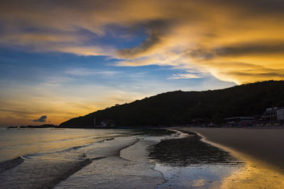 Scenic view of beach against sky during sunset