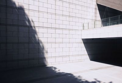 Sunlight falling on wall at sidewalk