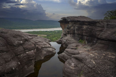 Rock formations on landscape against sky