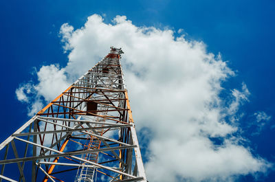 Metal tower for mobile radio communication on background of blue sky