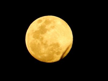 Low angle view of moon against clear sky at night