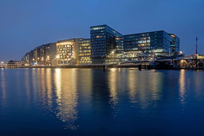 Illuminated city at waterfront