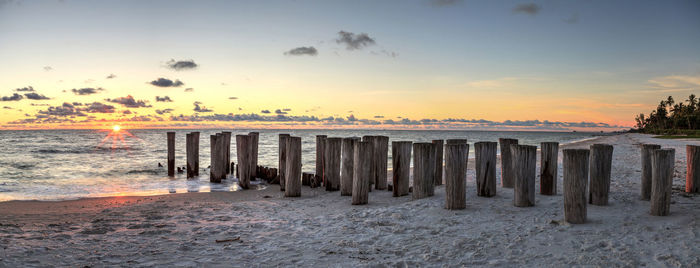 Dilapidated ruins of a pier on port royal beach at sunset in naples, florida