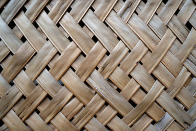 Woven coconut leaves as a traditional room divider.