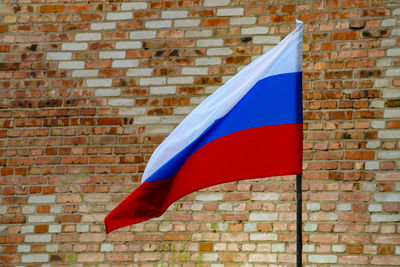 Russian flag against brick wall