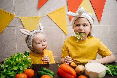 Portrait of cute girl eating food at home