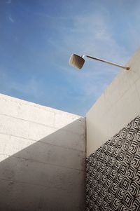 Low angle view of shower on wall against sky