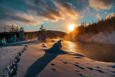 Scenic view of land against sky during sunset