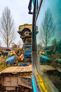 Low angle view of train on field against sky