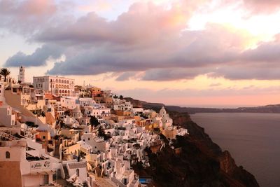 High angle view of buildings against cloudy sky