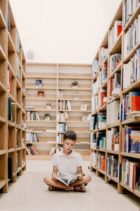 Child in school library. kids read books. little boy reading and studying. children at book store. 