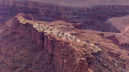 Rugged red sandstone rock formations tower above the eroded landscape