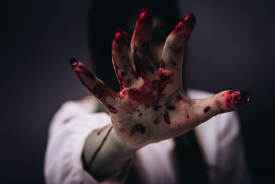 Close-up of human hand against black background